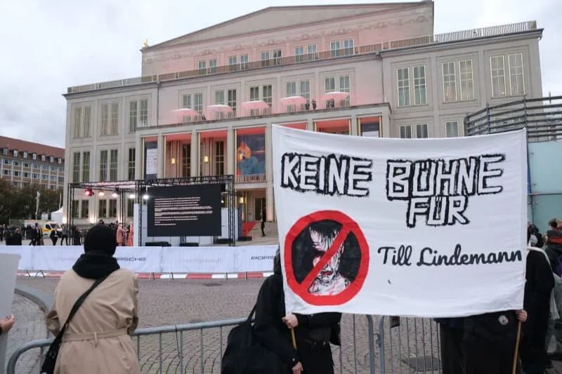 Protesters hold a banner with the words "No stage for Till Lindemann" during a protest against the participation of Rammstein singer Lindemann at the Leipzig Opera Ball. Sebastian Willnow/dpa
